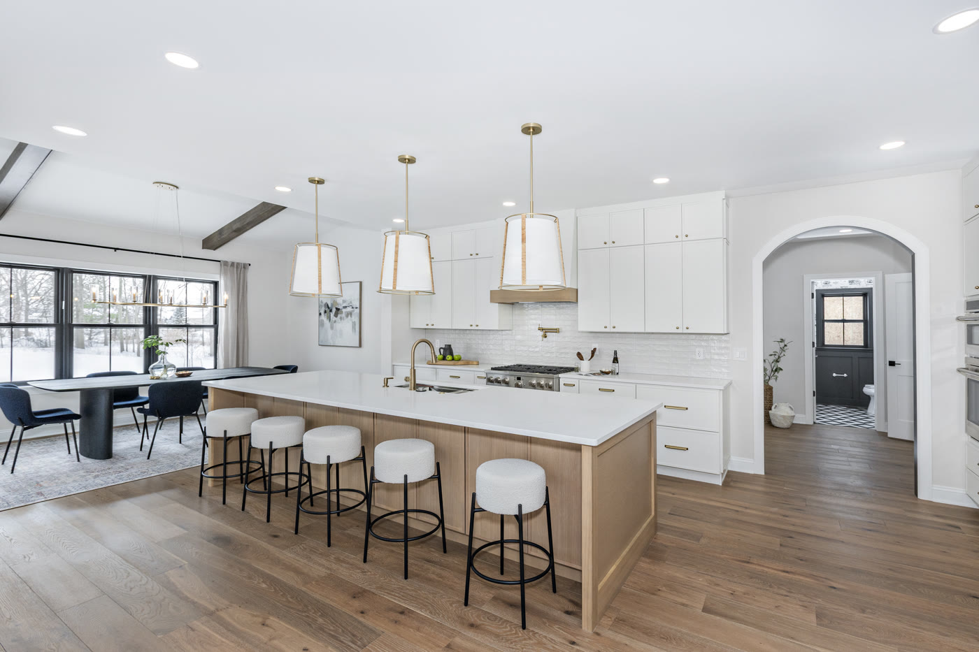 Luxury staged kitchen with gold pendant lights and white oak island by Homes Aglow